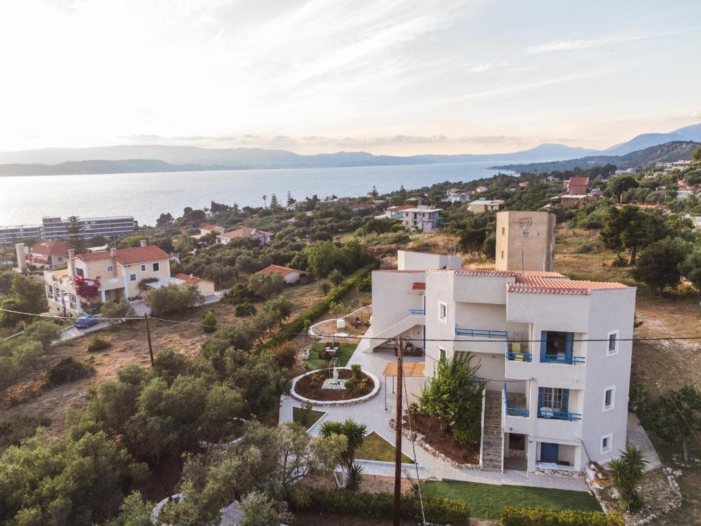 an aerial view of a white house with a view of the water at Fiore Di Mare Studios in Lassi