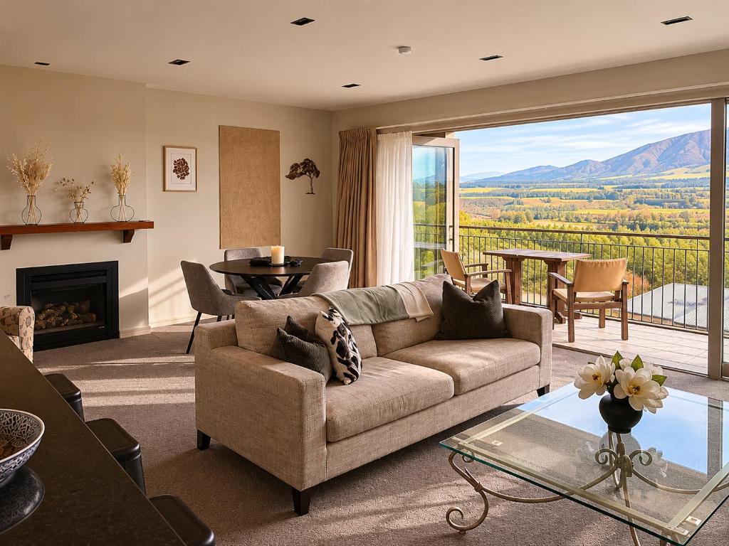 a living room with a couch and a fireplace at Best high country retreat - Terrace Downs in Windwhistle