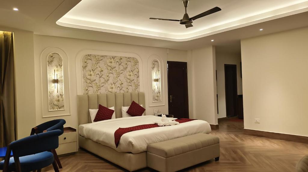 a bedroom with a large bed and a ceiling at The Yasa Hotel In Gangtok in Gangtok