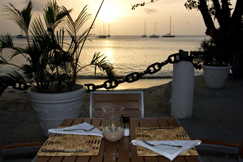 a picnic table with a view of the ocean at Bequia Plantation Hotel in Bequia