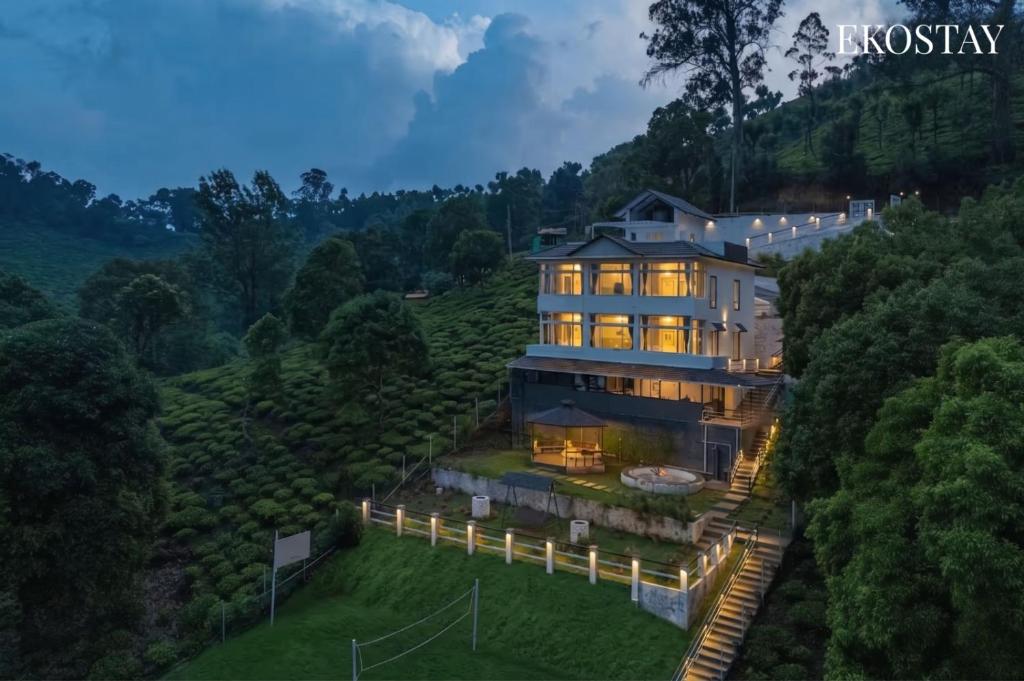 a large house on a hill with lights at EKOSTAY I Pearl House Villa I 360 Degrees Tea Estate in Ooty