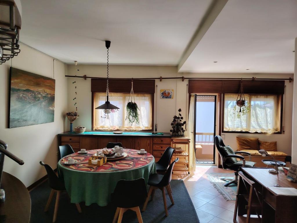 a living room with a table and chairs at Yellow House in Senhora da Hora