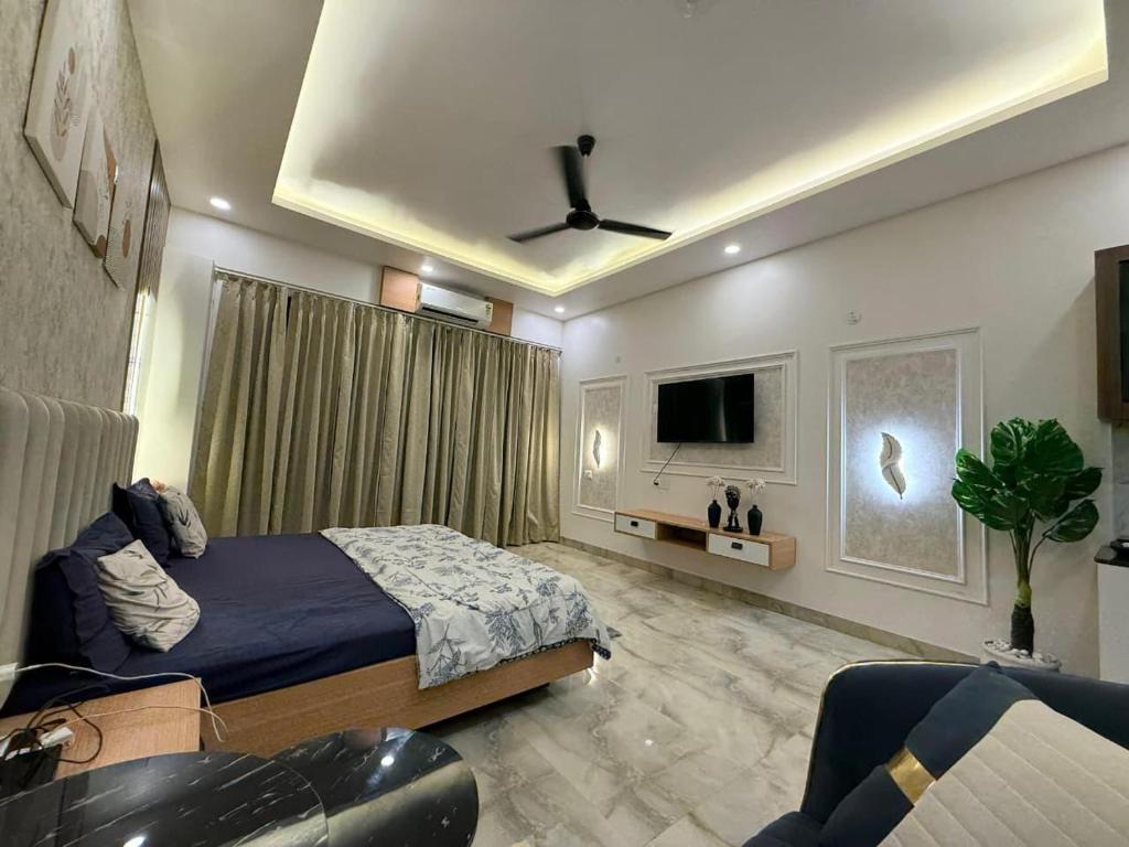 a bedroom with a bed and a ceiling fan at THE MOONLIGHT STUDIo in Ghaziabad