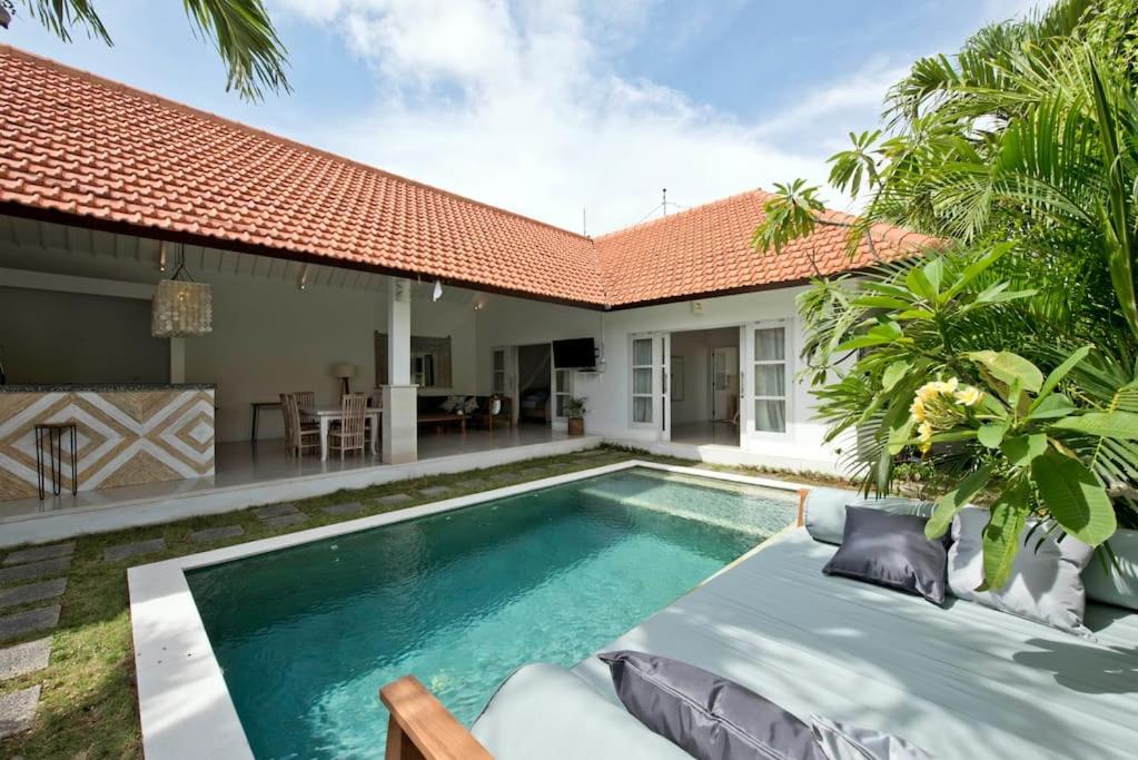 a swimming pool in the backyard of a villa at Villa Niluh in Canggu