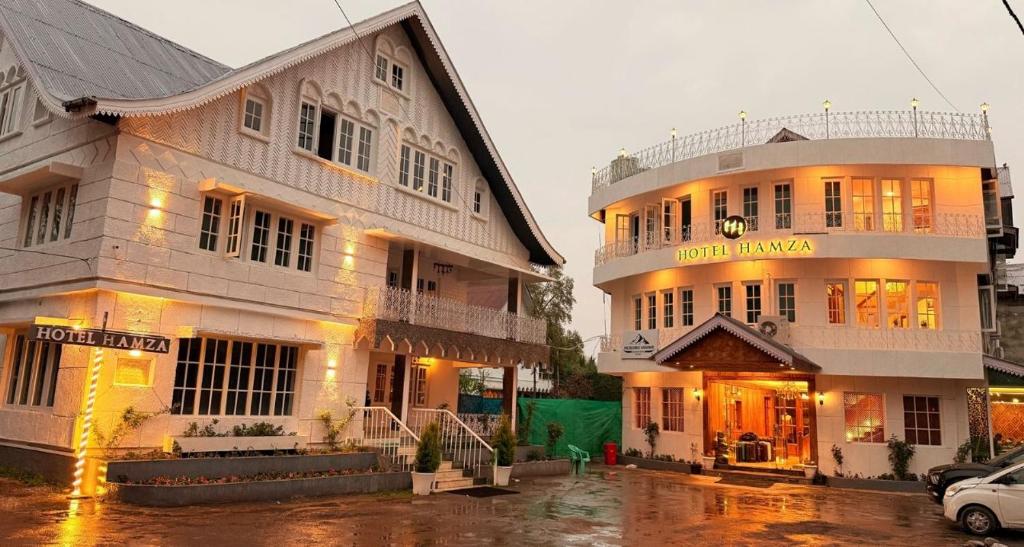a couple of buildings sitting next to each other at Hotel Hamza in Srinagar
