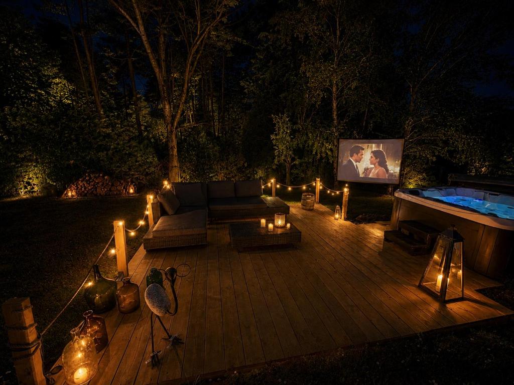 a patio with a couch and a pool with lights at Orfű Hillside in Orfű