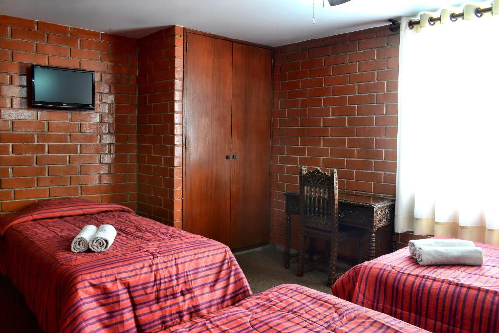 Postel nebo postele na pokoji v ubytování Hotel Esperanza