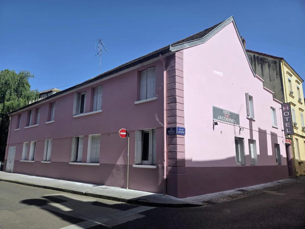 a pink building on the side of a street at Hôtel des Jacobines in Chalon-sur-Saône