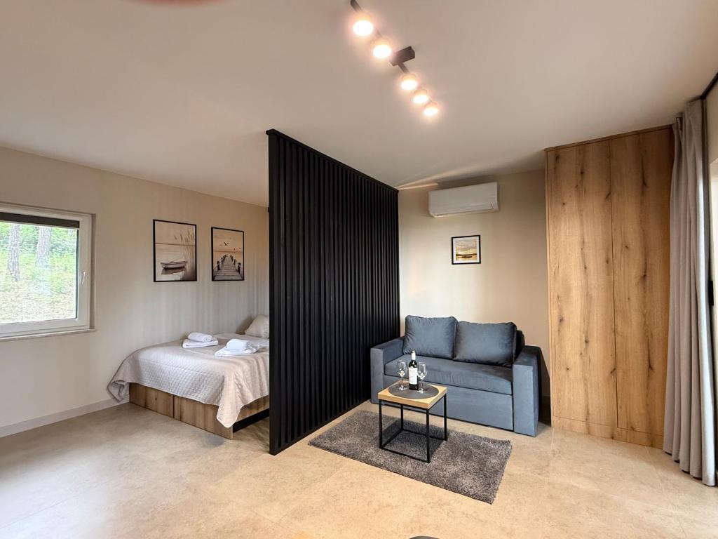 a bedroom with a bed and a blue couch at Turawa Lake Residence in Turawa