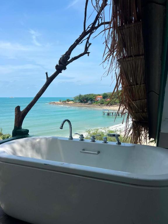 a bath tub with a view of the beach at Benny monkey house in Rayong