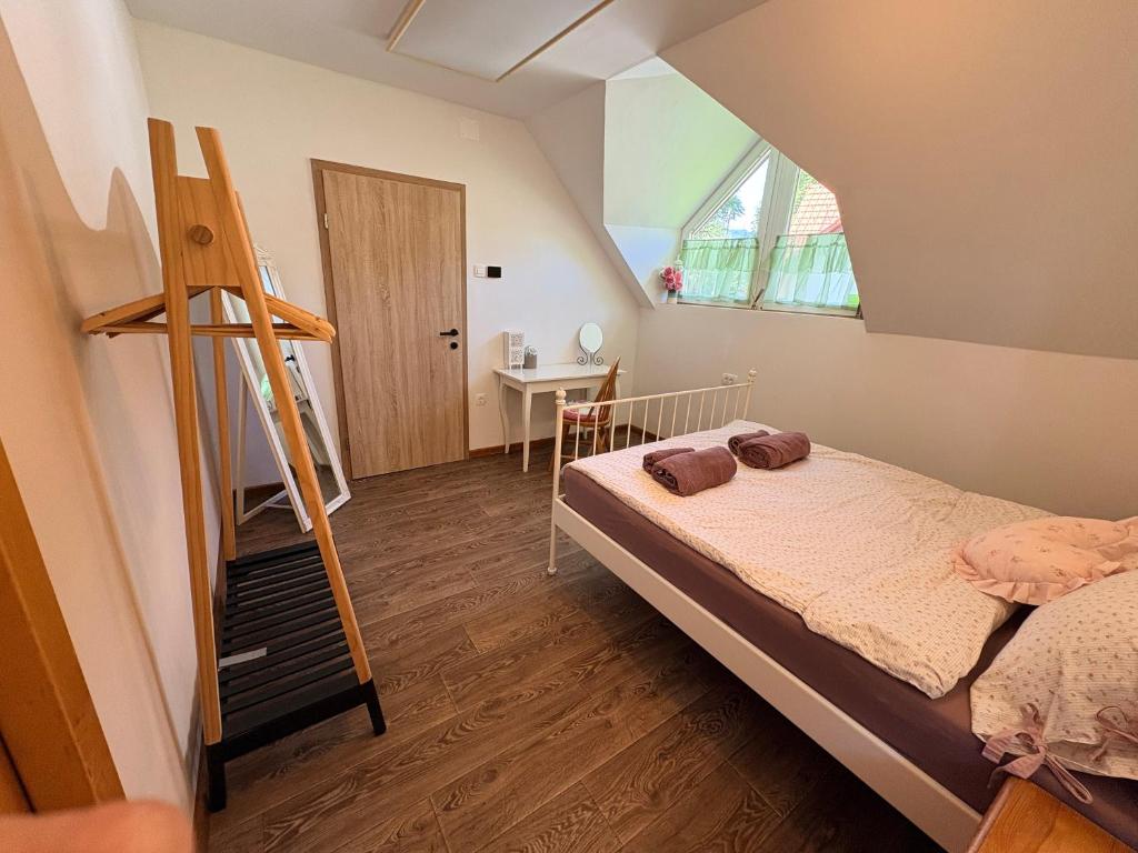 a bedroom with a bed and a ladder and a desk at Apartma Arja in Spodnje Gorje