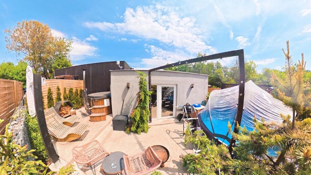 a backyard with a swimming pool and a house at Garden Residence - The Garage in Drahobudice