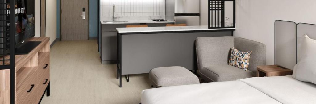 a small living room with a couch and a chair at StudioRes by Marriott Wilmington in Wilmington