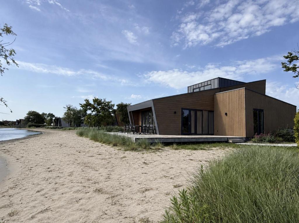 a house on the beach near the water at Beach House 314 in Hindeloopen