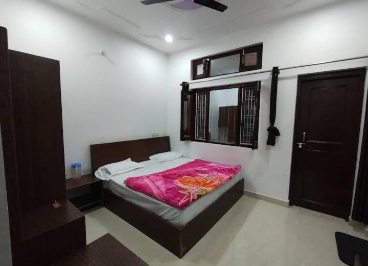 a bedroom with a bed and a window in it at Tapovan ganga view in Uttarkāshi