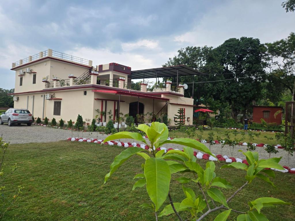 a house with a plant in front of it at Jim Corbett Guest House in Jhirna