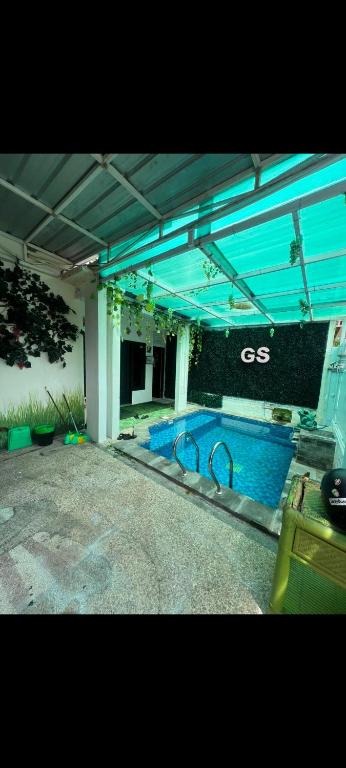 a large swimming pool in a large building with at Gandasari homestay banyuwangi in Banyuwangi
