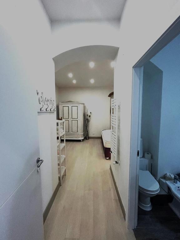 a hallway with a bathroom with a toilet and a sink at Family and view in Scandicci