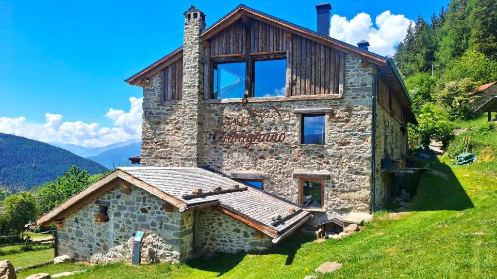 a stone house on top of a hill at Chalet Cormignano in Vezza dʼOglio
