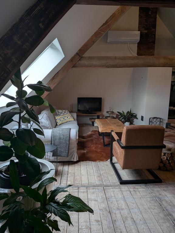 a living room with a couch and a table at BoerLangendijk in Rucphen