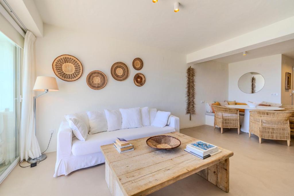 a living room with a white couch and a wooden table at Apartment with sea view Javea in Jávea