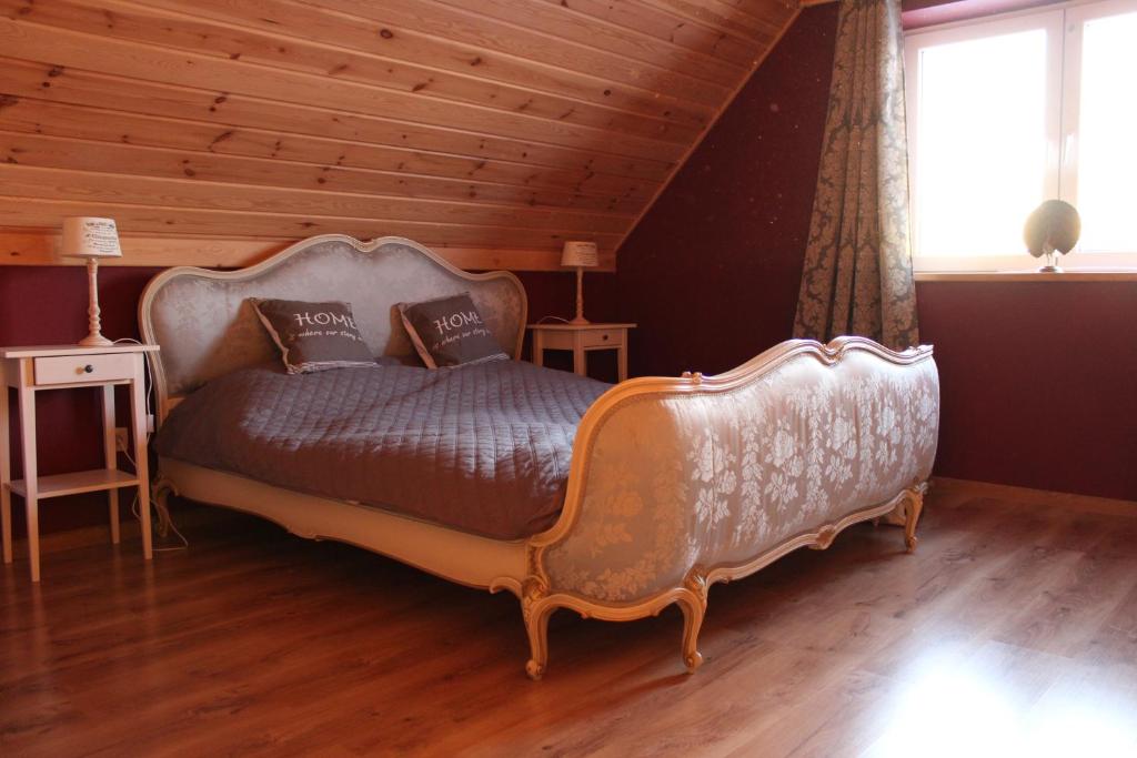 ein Schlafzimmer mit einem großen Bett und einer Holzdecke in der Unterkunft Cisza jak makiem zasiał in Kobyla