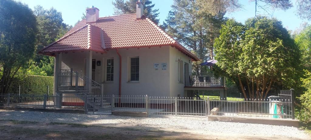 a small white house with a fence at Apartament AURA - Cichy Zakątek - Kujanki in Kujanki