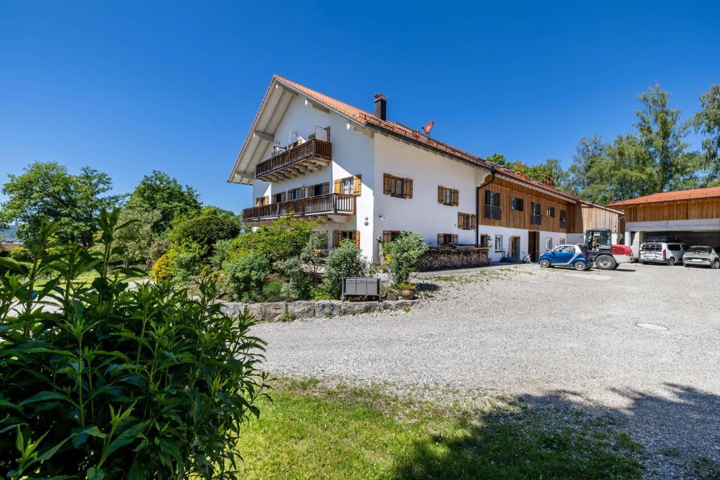 a large white building with a parking lot at Hof am Ammersee in Pähl