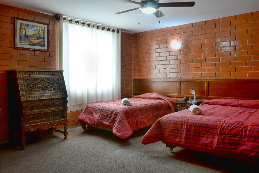 Postel nebo postele na pokoji v ubytování Hotel Esperanza