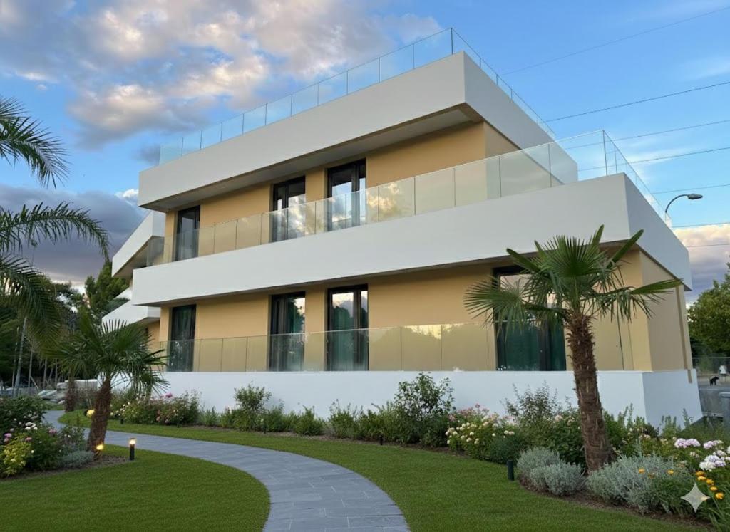 a rendering of a house with palm trees in front at Rialto Millau Coliving in Villaviciosa de Odón