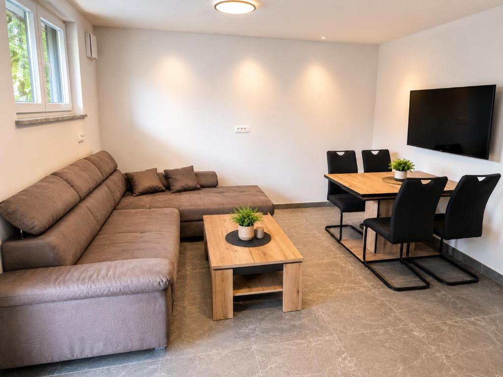 a living room with a couch and a table at Apartment Beli in Radovljica