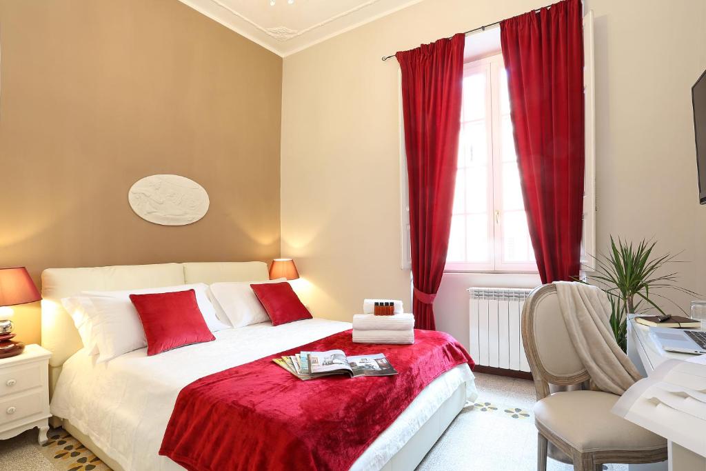 a bedroom with a bed with a red blanket at Liberty Rome Apartment - Liberty Collection in Rome