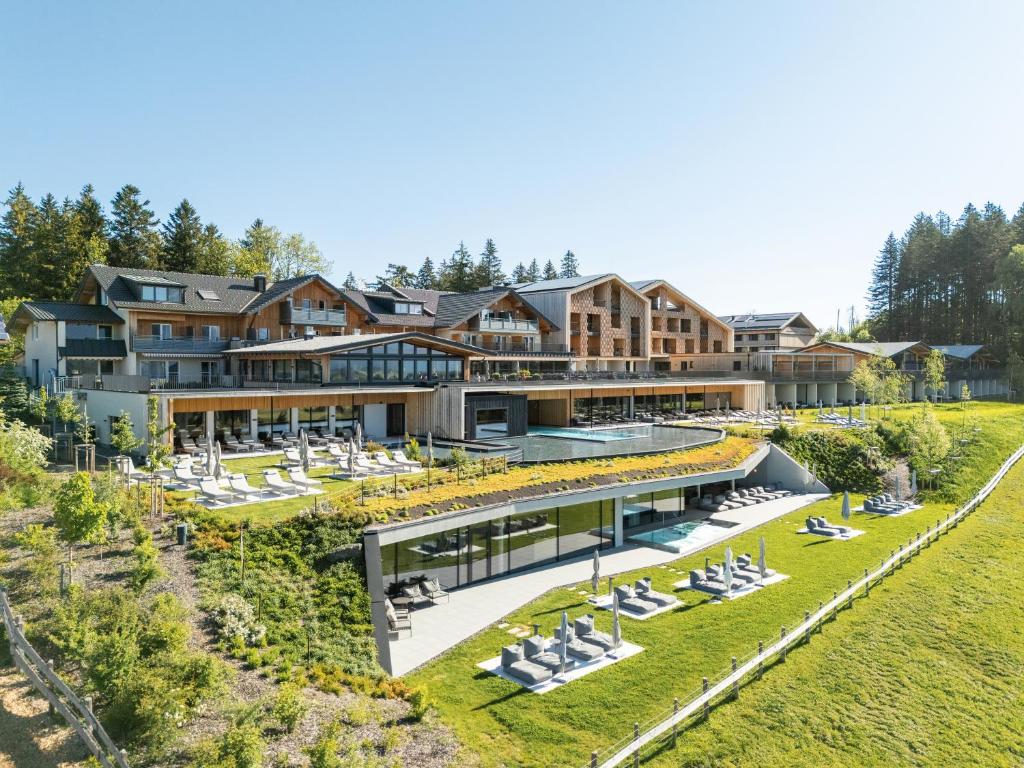 an aerial view of a resort with lounge chairs at PANORAMA Allgäu Spa Resort in Seeg