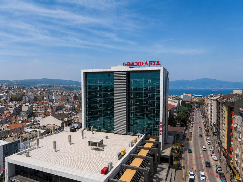 a tall building with a sign on top of it at Grand Asya Hotel in Bandırma