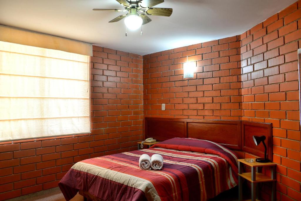 Postel nebo postele na pokoji v ubytování Hotel Esperanza