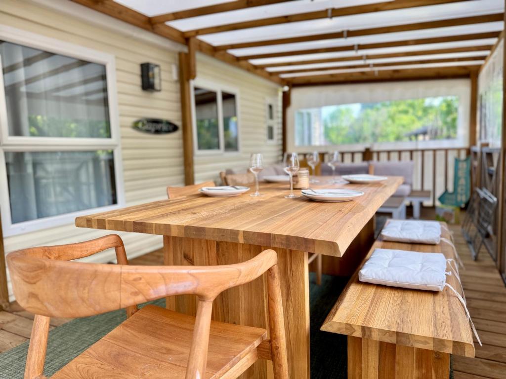 a large wooden table and chairs on a porch at My Maui Home in Salles