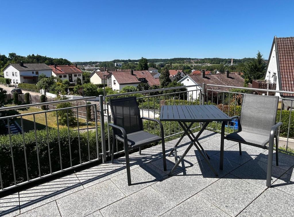 a table and two chairs on a balcony with a view at Apartment Ilmtalblick in Pfaffenhofen an der Ilm