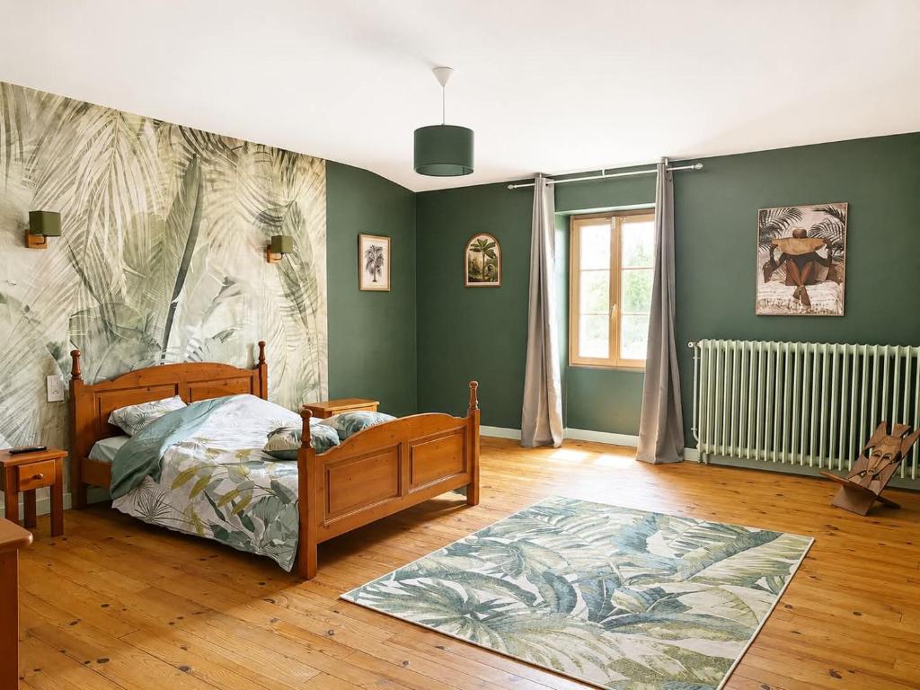 a bedroom with a bed and a rug at chambres nature in La Celle-sous-Gouzon