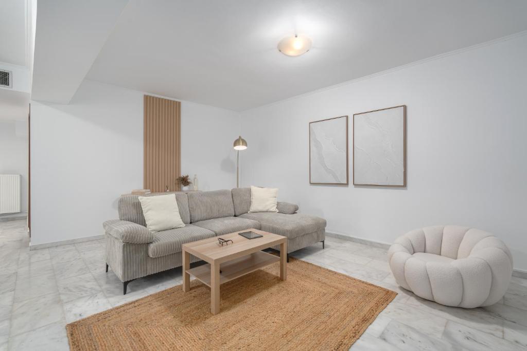 a living room with a couch and a coffee table at Riviera by Urban Luxy in Athens