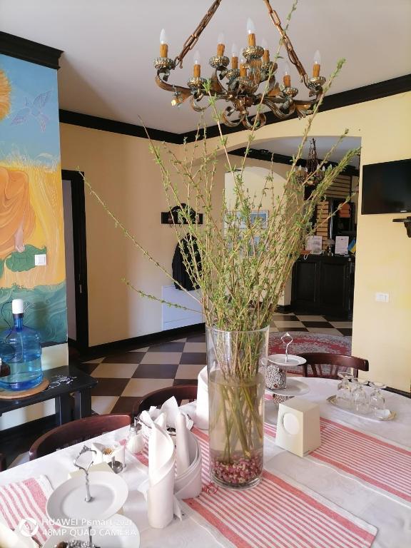 a table with a vase with flowers in it at Chalet Zolota Pidkova&River 1 in Slavske