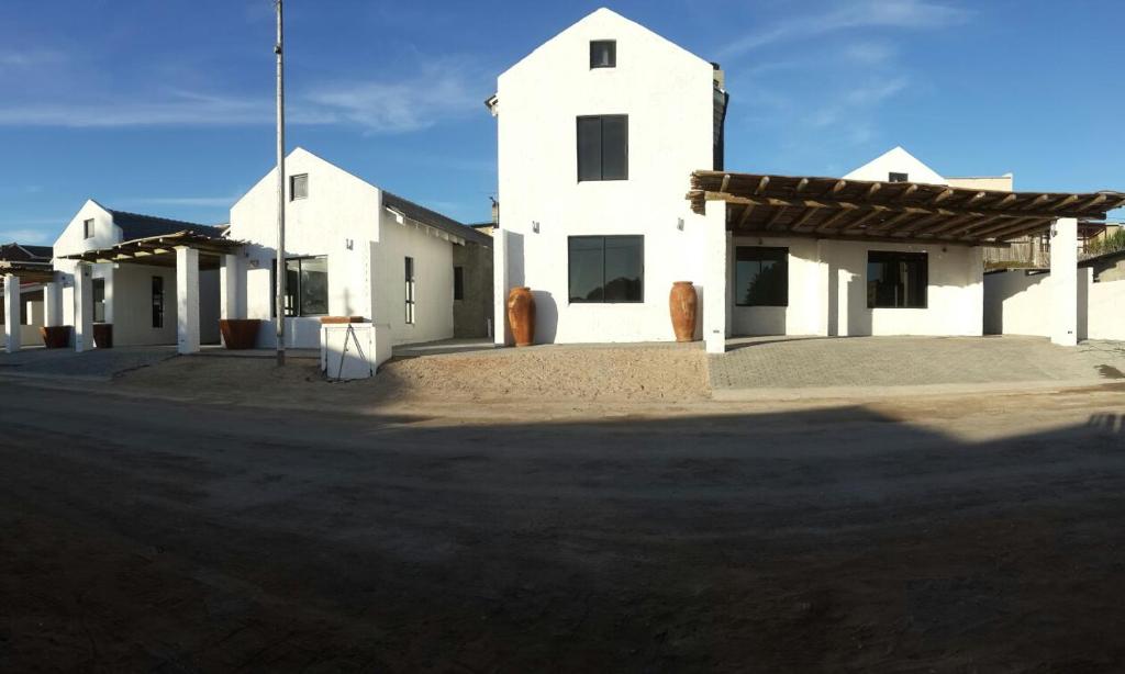 a white building with a cross on top of it at Sunset Lagoon in Port Nolloth