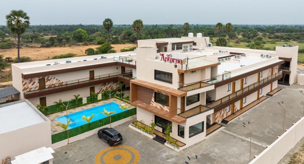 an aerial view of a house with a swimming pool at La Antaraa in Arumuganeri