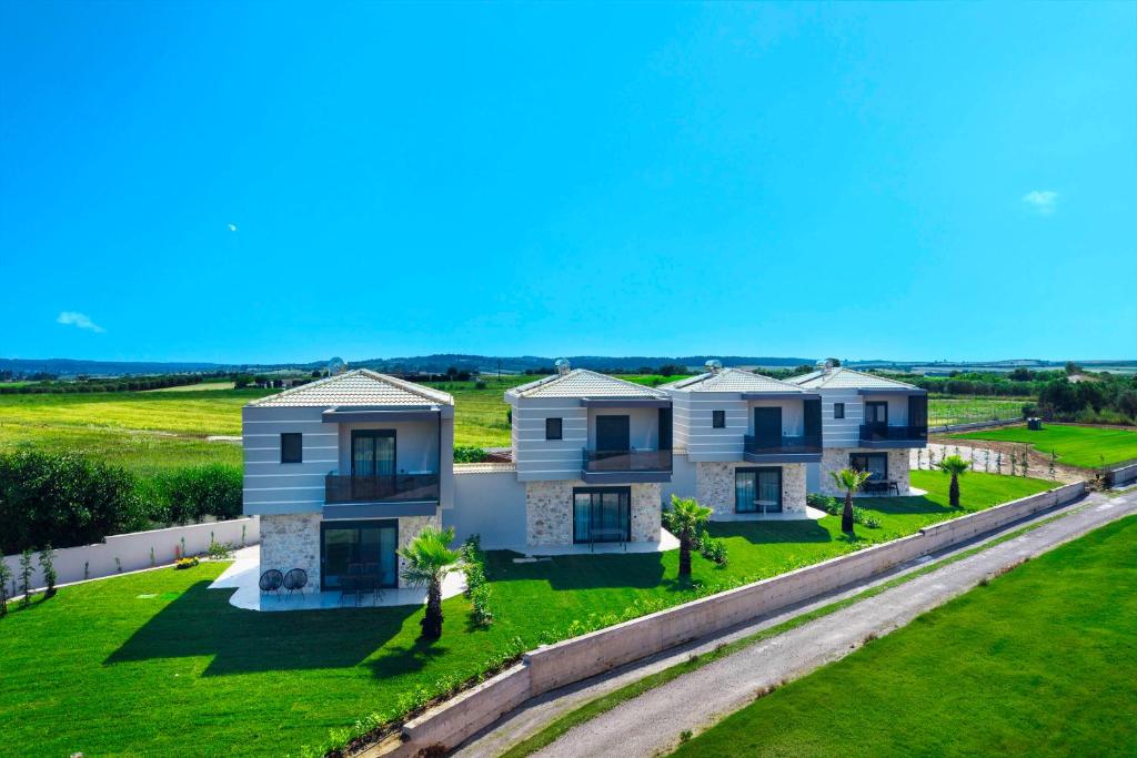 an aerial view of a house with a yard at Adessa Villas in Afitos