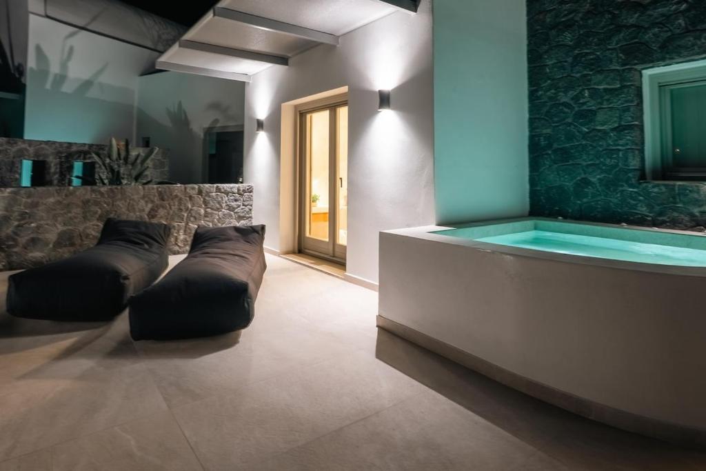 a room with a swimming pool in a building at Serenity Collection Suites in Karterados