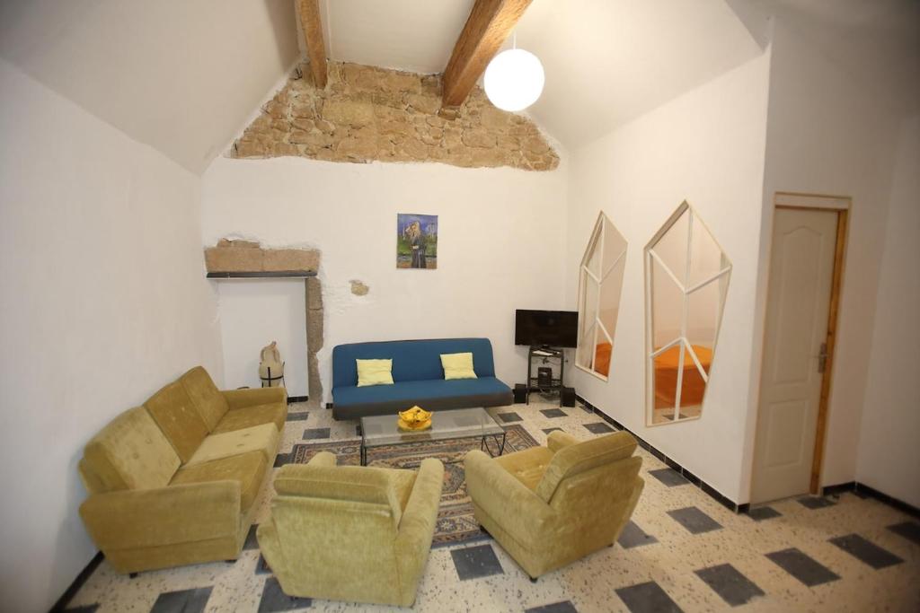 a living room with two chairs and a couch at chez nous - la une in Marseillan