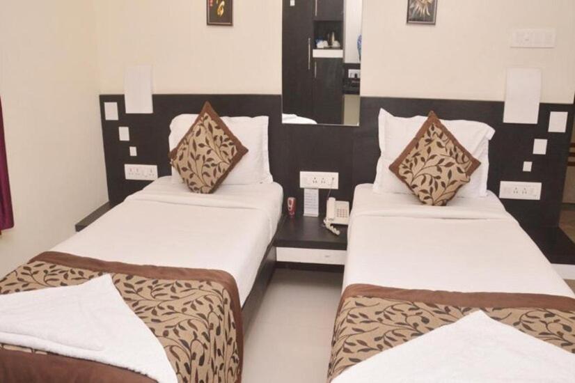 two beds in a hotel room with two at SHIVAM Hotel in Muzaffarpur