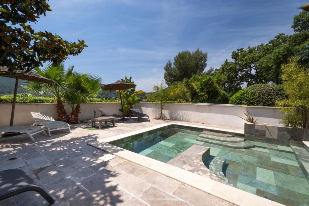 a swimming pool in the backyard of a house at Chambres D'hôtes - Le Mas Du Rocher in Hyères
