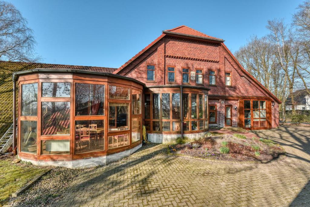 a large brick house with glass windows at Haus Habbinga in Ovelgönne