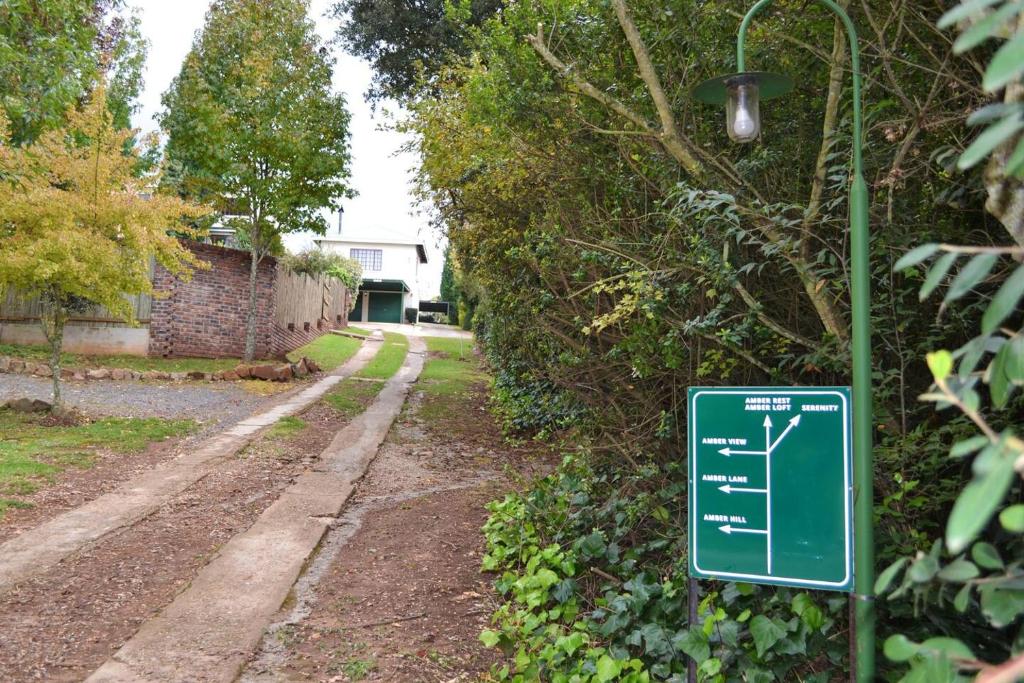 a street sign in front of a house at Amber Collection in Dullstroom