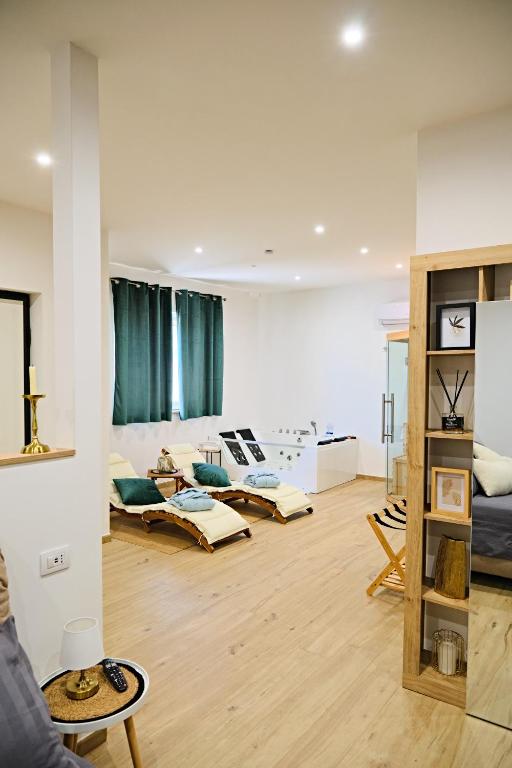 a living room filled with furniture on a hard wood floor at RG MAISON - Suite 29 in Morino